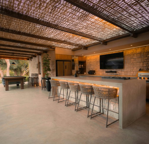 Modern outdoor kitchen with island and bar stools