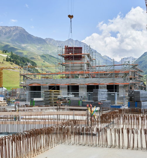 a construction site with cranes and a building under construction