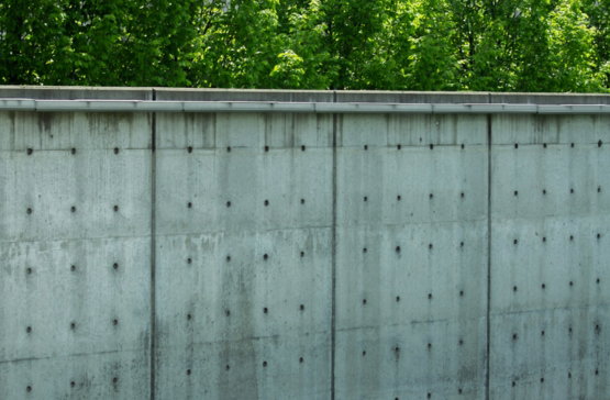 a man riding a skateboard on top of a cement wall