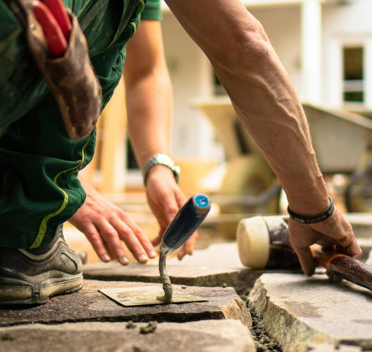 a-man-working-on-a-piece-of-concrete.jpg a man working on a piece of concrete