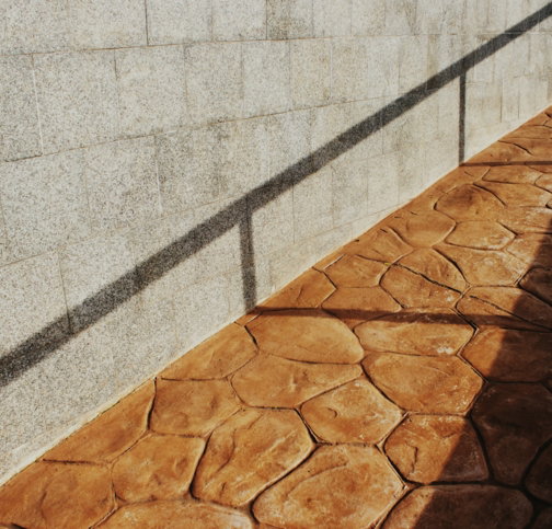 shadows-cast-on-a-textured-wall-and-patterned-walkway-.jpg Shadows cast on a textured wall and patterned walkway.